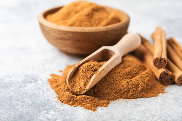 istock Cinnamon powder on a textured wooden background. Spicy spice for baking, desserts and drinks. Fragrant ground cinnamon. Cinnamon stick. Place for text. Copy space. 2155182794