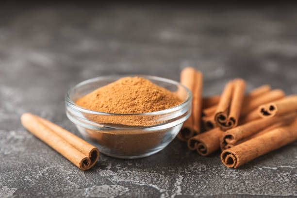 istock Cinnamon sticks on a textured wooden background. Cinnamon roll. Spicy spice for baking, desserts and drinks. Fragrant ground cinnamon. cinnamon powder Close-up. Place for text. copy space 2155183007