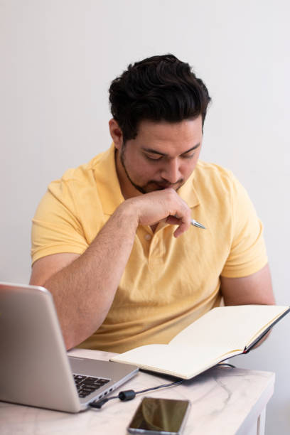istock Young student with stress trying to resolve a problem in his laptop 2155183450