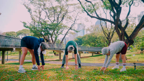 istock Group of elderly people exercising in the garden . 2155185277