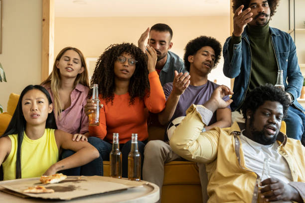 istock Friends Reacting Emotionally While Watching TV at Home 2155187976
