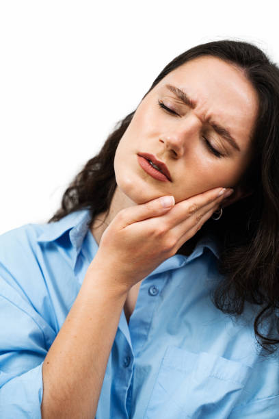 istock Tooth Ache Before Visit Dentist. Suffering Young Woman With Painful Toothache On White Background. Attractive Girl with Toothache Touches Her Cheek And Feel Pain in Her Teeth. 2155190246