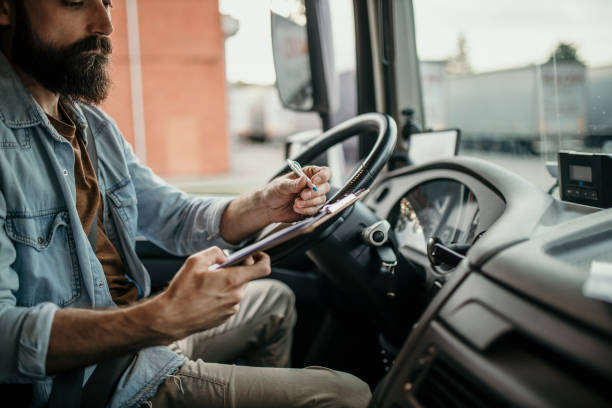 istock A young man sits in the cab of a cargo truck 2155191956