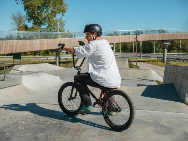 istock Young BMX bicycle rider smiling, posing in skatepark 2155198531