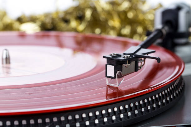 Vinyl records on pillow with Christmas tree on background. Festive holiday decorations.
