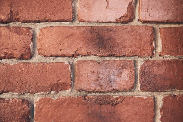 istock Abstract weathered texture stained with aged paint, rough rusty masonry blocks. Close-up of a brick wall. Overlay for your design with the ability to copy. 2155203631
