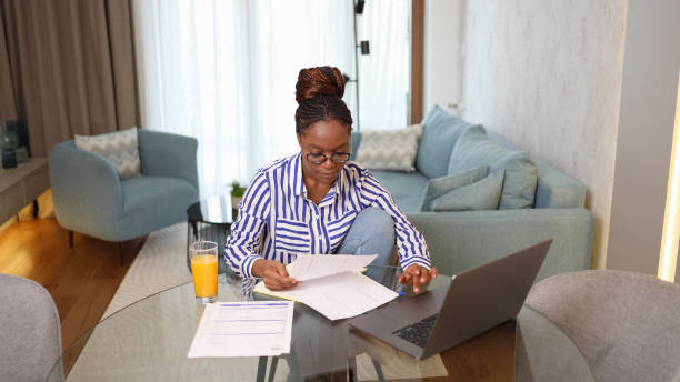 istock Happy woman planning her finances at home 2155203795