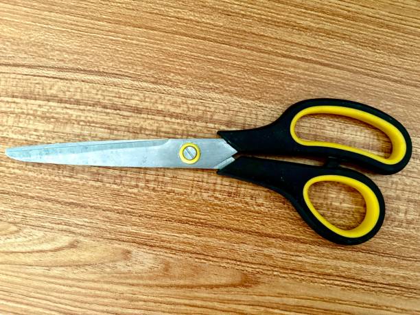 istock A pair of scissors on a wood table 2155204064