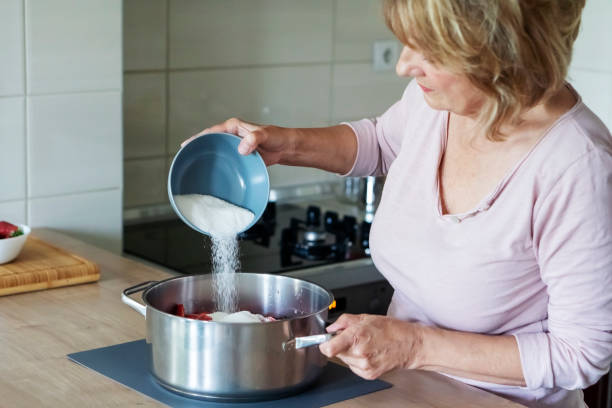 Senior woman Preparing Homemade Strawberry Jam