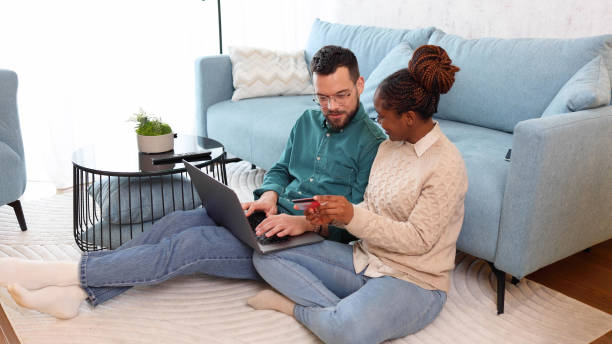istock Happy couple having fun while shopping online 2155204269