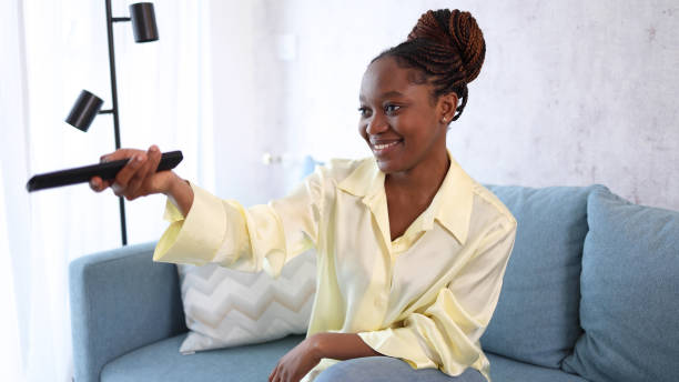 istock African American woman relaxing with TV program 2155204349