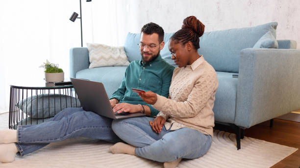 istock Happy couple having fun while shopping online 2155204583