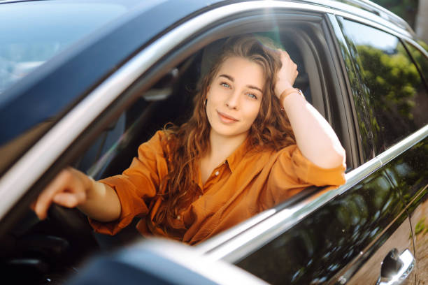 istock Relaxed woman enjoys drive while sitting in a car. 2155205104