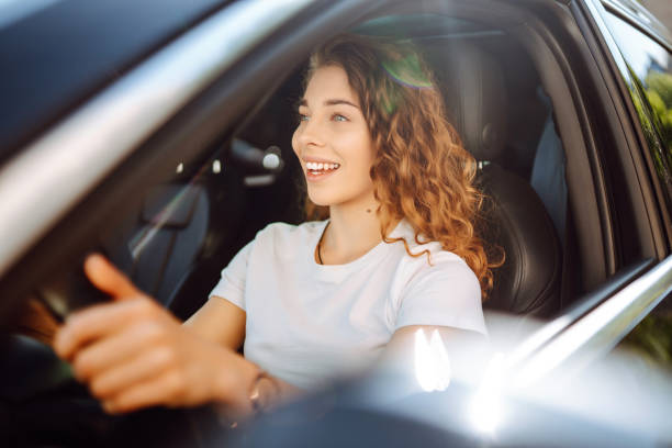 istock Relaxed woman enjoys drive while sitting in a car. 2155205106