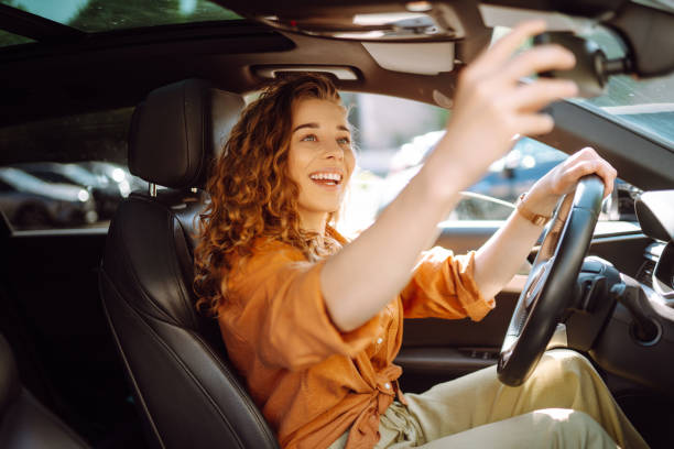 istock Relaxed woman enjoys drive while sitting in a car. 2155205113