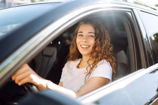 istock Relaxed woman enjoys drive while sitting in a car. 2155205114