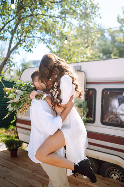 istock Beautiful wedding couple in camping trailer. 2155205861