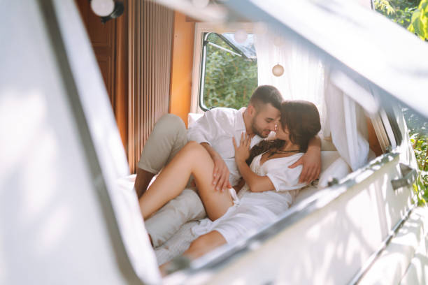 istock Beautiful wedding couple in camping trailer. 2155205880