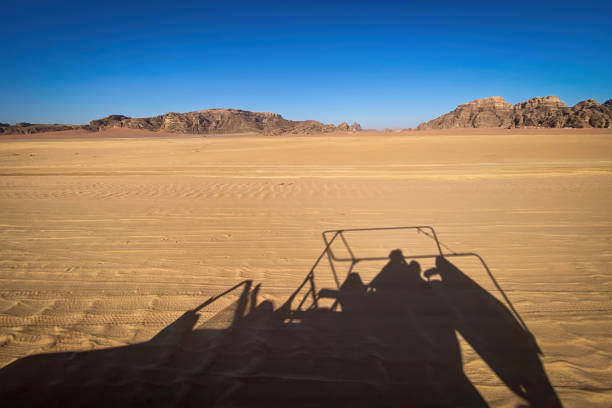 istock Shadow of a jeep driving through Wadi Rum desert in Jordan 2155207804
