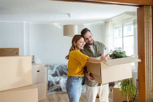 istock Happy couple taking selfie while moving into new home 2155207813