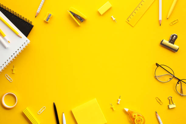 istock Frame of office supplies on yellow background. Flat lay, top view, copy space. 2155207966