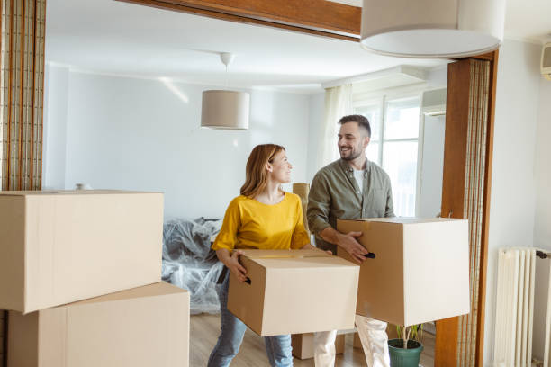 istock Cheerful young couple moving in new home 2155208279