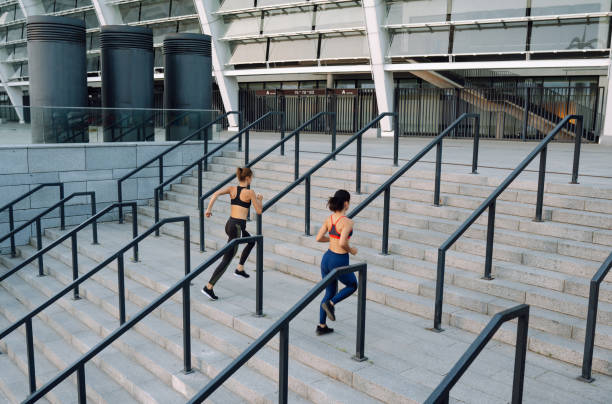 istock Two attractive female exercising outdoor. 2155208356