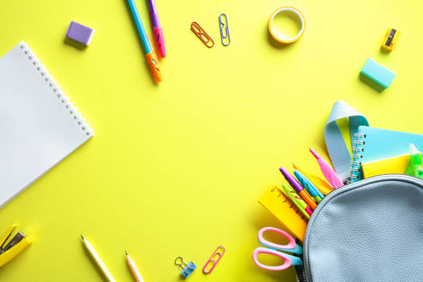 istock Back to school concept with colorful stationery scattered on a bright yellow background. Flat lay, top view, copy space. 2155208365