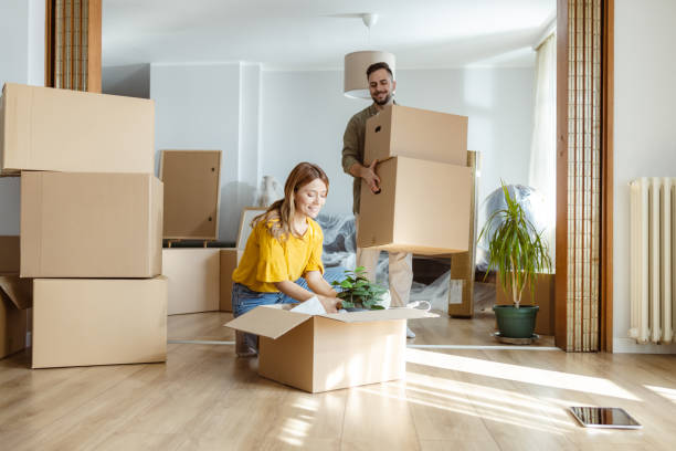 istock Moving In: Cheerful couple moving in new home 2155208381