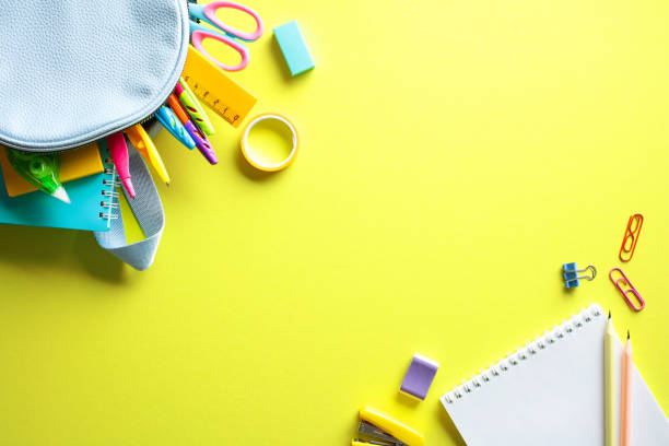 istock Vibrant back to school supplies on yellow background. Flat lay, top view. 2155208615