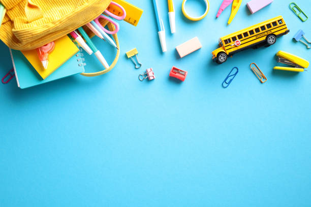 istock Back to school concept with vibrant school supplies on blue background. Flat lay, top view, copy space. 2155208769