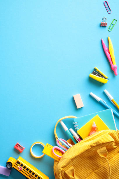 istock Vibrant back to school supplies on blue background. Flat lay, top view, copy space. 2155209534
