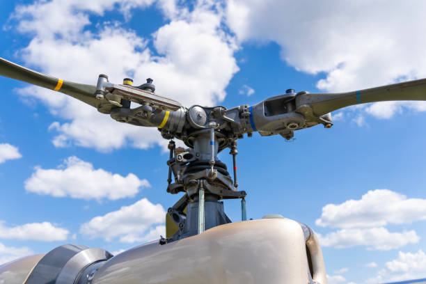 Military helicopter main rotor with blue cloudy sky in the background