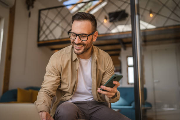 istock Adult man sit and use mobile phone for text message or surf at home 2155214973