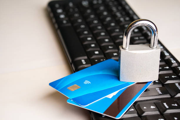 istock A padlock over a pair of credit cards next to a computer keyboard on a white background with copy space 2155218107