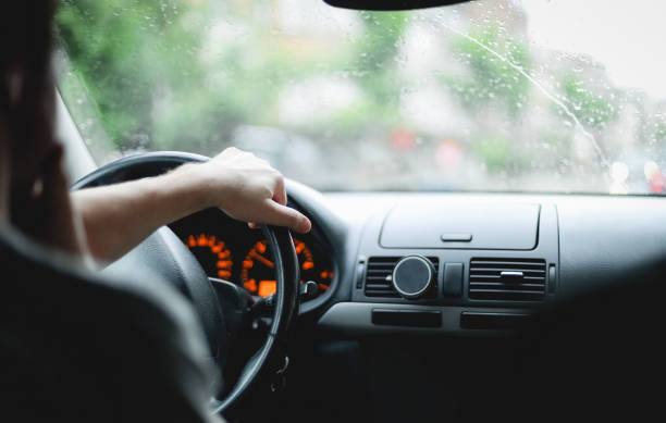 istock A young caucasian guy keeps his hand on the steering wheel while driving a car. 2155218391