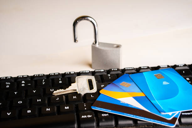istock Online shopping security concept, credit cards on a computer keyboard and a padlock with a key. 2155218448