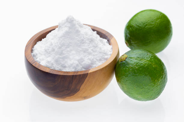 istock Baking soda in wooden container and lime, isolated on white 2155218835