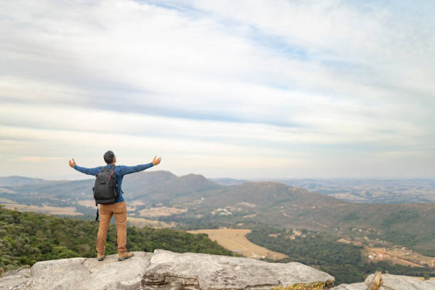 istock Man with open arms on top of the mountain 2155220116