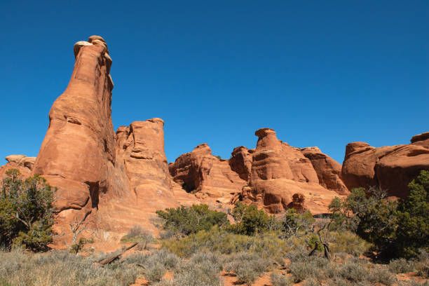 istock Red rock formation along Footpath to Broken Arch in Arches National Park, US. 2155221503