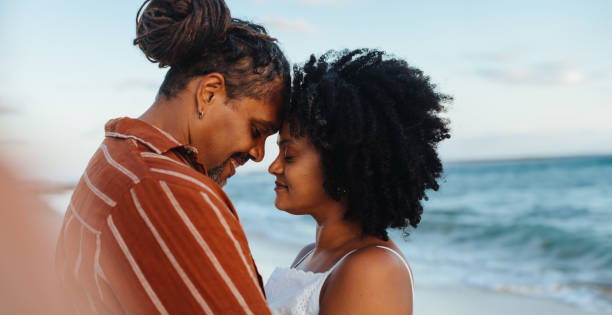istock Authentic couple in love sharing an intimate moment on the beach 2155223530
