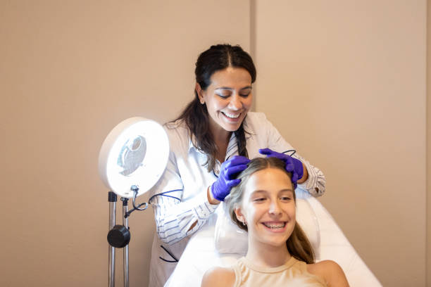 istock Dermatologist examining her patient's scalp 2155224490
