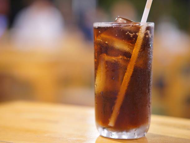 istock Cola with ice cubes on a dark lights bokeh background 2155225943