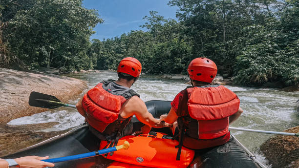 istock whitewater rafting point of view Asian Rafters challenging Running The Rapids, rafting on whitewater river, southeast asia 2155227188