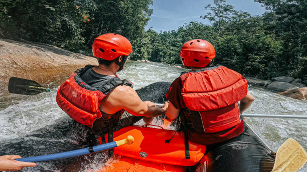 istock whitewater rafting point of view Asian Rafters challenging Running The Rapids, rafting on whitewater river, southeast asia 2155227189