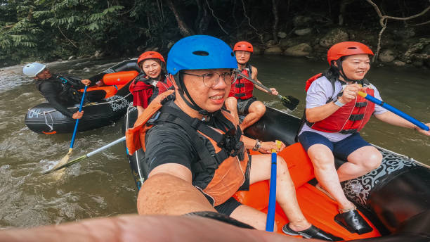 istock Asian Chinese friends selfie while whitewater rafting on river, southeast asia 2155227199