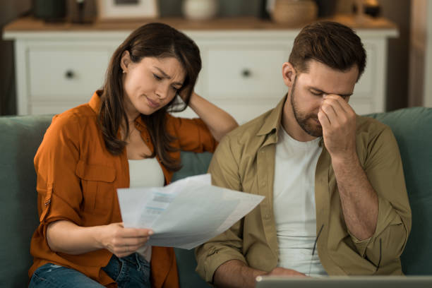 istock Young couple having problems with online banking at home. 2155230883