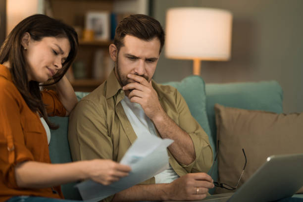istock Young couple having problems with online banking at home. 2155230927