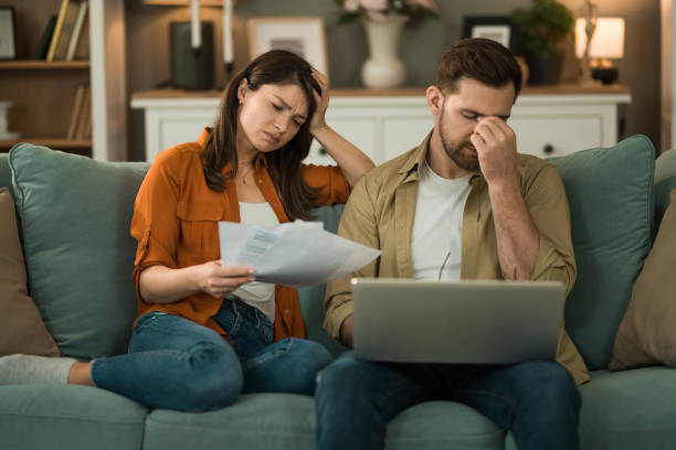 istock Young couple having problems with online banking at home. 2155230993