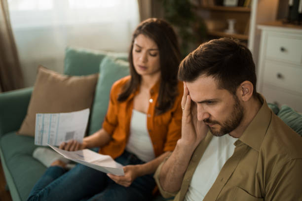 istock Worried couple having problems with their financial bills at home. 2155231099